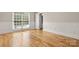 Empty bedroom with hardwood floors and a view through the open window at 4150 Summit Ridge Ln, Denver, NC 28037