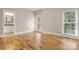 Bright, empty bedroom with hardwood floors and sunlight streaming in through the windows at 4150 Summit Ridge Ln, Denver, NC 28037