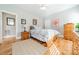 Bright bedroom featuring hardwood floors and a wooden dresser at 4150 Summit Ridge Ln, Denver, NC 28037