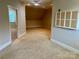 Bonus room view with neutral carpet and trim, connecting doorways, and a ceiling fan at 4150 Summit Ridge Ln, Denver, NC 28037