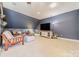 Spacious bonus room with a large TV and comfortable seating at 4150 Summit Ridge Ln, Denver, NC 28037