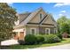 Charming two-story home with stone accents, manicured landscaping, and a three-car garage at 4150 Summit Ridge Ln, Denver, NC 28037