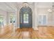 Bright foyer features hardwood floors, elegant lighting, and arched doorway at 4150 Summit Ridge Ln, Denver, NC 28037