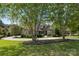 Charming home featuring mature trees, manicured landscaping, and circular driveway at 4150 Summit Ridge Ln, Denver, NC 28037