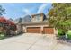 Attached two-car garage with driveway and mature landscaping at 4150 Summit Ridge Ln, Denver, NC 28037