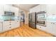 Modern kitchen featuring stainless steel appliances and hardwood floors at 4150 Summit Ridge Ln, Denver, NC 28037