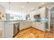 Spacious kitchen with white cabinets, stainless steel appliances, and light blue tile backsplash at 4150 Summit Ridge Ln, Denver, NC 28037