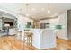 Modern kitchen with white cabinets, breakfast bar and stainless steel appliances at 4150 Summit Ridge Ln, Denver, NC 28037