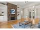 Bright, open living room featuring hardwood floors, stone fireplace and built-in shelving at 4150 Summit Ridge Ln, Denver, NC 28037
