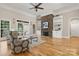 Light-filled living room with hardwood floors, stone fireplace, and built-in shelving at 4150 Summit Ridge Ln, Denver, NC 28037