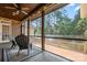 Relaxing screened-in porch with wood ceiling, ceiling fan, and outdoor seating area at 4150 Summit Ridge Ln, Denver, NC 28037