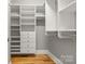 Walk-in closet featuring custom shelves, drawers, and hanging rods at 4150 Summit Ridge Ln, Denver, NC 28037