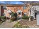 Brick front exterior of charming townhome with well-manicured landscaping at 4291 Melrose Club Dr, Matthews, NC 28105