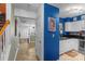 Bright kitchen with white cabinets, blue walls, and black countertops at 4291 Melrose Club Dr, Matthews, NC 28105