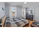 Bright bedroom featuring hardwood floors and a plaid comforter at 44339 Us 52 N Hwy, Richfield, NC 28137