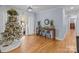 Bright entryway with hardwood floors, a console table, and a Christmas tree at 44339 Us 52 N Hwy, Richfield, NC 28137