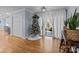 Spacious living area with hardwood floors, a Christmas tree, and access to a sunroom at 44339 Us 52 N Hwy, Richfield, NC 28137