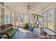 Bright sunroom features a swing, wicker furniture, and access to the backyard at 44339 Us 52 N Hwy, Richfield, NC 28137