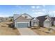 Two-story home with gray siding, two-car garage, and driveway at 5007 Grand Champion Ct, Iron Station, NC 28080