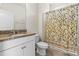 Bathroom with granite countertop, shower, and floral curtain at 5007 Grand Champion Ct, Iron Station, NC 28080