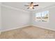 Spacious bedroom with ceiling fan and neutral carpeting at 5007 Grand Champion Ct, Iron Station, NC 28080