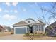 Attractive craftsman style home with gray siding, two-car garage, and landscaping at 5007 Grand Champion Ct, Iron Station, NC 28080