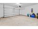 Bright garage interior with automatic door and storage at 5007 Grand Champion Ct, Iron Station, NC 28080