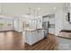 Modern kitchen with white cabinets, island, and stainless steel appliances at 5007 Grand Champion Ct, Iron Station, NC 28080