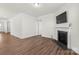 Living room featuring a corner fireplace and hardwood floors at 5007 Grand Champion Ct, Iron Station, NC 28080