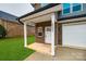 Inviting front entrance with a covered porch and brick exterior at 5050 Ashley Pl, Bessemer City, NC 28016