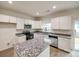 Modern kitchen with white cabinets, granite countertops and island at 5050 Ashley Pl, Bessemer City, NC 28016