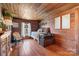 Bedroom with wood walls, a daybed, and antique chest at 673 Cape Hickory Rd, Hickory, NC 28601