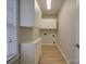 Laundry room with white cabinets and wood floors at 6922 Concord Hwy, Monroe, NC 28110