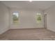 Spacious bedroom with two windows and neutral carpeting at 804 Pierce Ave, Mount Holly, NC 28120