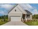 Beige house with white garage door and landscaping at 804 Pierce Ave, Mount Holly, NC 28120