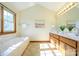 Double vanity bathroom with soaking tub and large mirror at 8147 Camelot Dr, Harrisburg, NC 28075