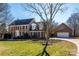 Brick house with attached garage and landscaped lawn at 8147 Camelot Dr, Harrisburg, NC 28075