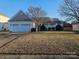 Ranch style home with attached garage and landscaped lawn at 8726 Castle Cliff Dr, Matthews, NC 28105