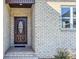 Dark brown front door with oval glass window and brick entryway at 1033 12Th Avenue Nw Dr, Hickory, NC 28601