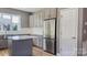 Island kitchen features stainless steel refrigerator and gray cabinets at 1033 12Th Avenue Nw Dr, Hickory, NC 28601