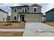 Charming two-story home featuring a neutral color scheme and a spacious two-car garage at 1412 Windy Park Dr, Stanley, NC 28164