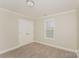 Small bedroom with neutral walls and carpeted floor at 19054 Long Pond Ln, Cornelius, NC 28031