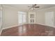 Living room with hardwood floors, built-in shelving, and French doors at 19054 Long Pond Ln, Cornelius, NC 28031