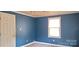 Blue bedroom with window, ceiling fan and door at 3169 Eden Terrace Ext, Rock Hill, SC 29730
