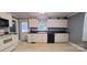 White kitchen cabinets, black countertops, and tiled floor at 3169 Eden Terrace Ext, Rock Hill, SC 29730