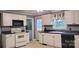 Kitchen with white cabinets, black countertops, and a stove at 3169 Eden Terrace Ext, Rock Hill, SC 29730