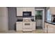 White kitchen cabinets, black countertops, and a built-in microwave at 3169 Eden Terrace Ext, Rock Hill, SC 29730