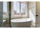 Bathroom showcasing a freestanding tub beneath a window with natural light at 3432 Greene Rd, Monroe, NC 28110
