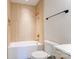 Modern bathroom featuring a white tub and shower with gold fixtures and wooden paneling at 3432 Greene Rd, Monroe, NC 28110