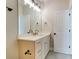 Modern bathroom featuring a white vanity with gold hardware and a large mirror with modern light fixtures at 3432 Greene Rd, Monroe, NC 28110